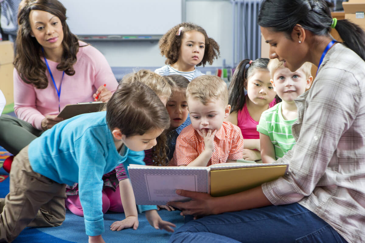 Students sitting in reading circle with teacher.